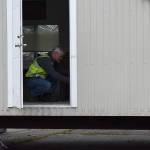 Photo by Haley Ausbun. An electrician inspects one of the four rooms in the first modular unit that will be ready for those under quarantine for COVID-19, coronavirus.