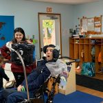 Steve Brajas reads a tale to preschool children at Mt. Tahoma Montessori, aided by a computer that detects where he is looking and speaks for him. Photo courtesy Mt. Tahoma.