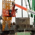A construction worker measures a drill shaft during installation at the future Sound Transit Kent/Des Moines light rail site on Oct. 7. Olivia Sullivan/the Mirror