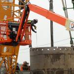 A construction worker measures a drill shaft during installation at the future Sound Transit Kent/Des Moines light rail site on Oct. 7. Olivia Sullivan/the Mirror