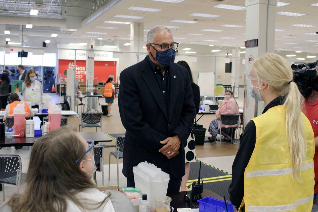Gov. Inslee (center) meets with Auburn Vaccine Clinic staff member on Tuesday, June 22, 2021. Inslee visited the clinic to promote vaccinations in lower King County. Photo by Henry Stewart-Wood.