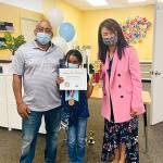 A spelling bee winner poses with her award. Courtesy photo