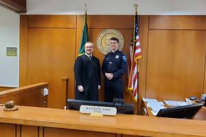 Judge Matthew York and Auburn Police Departments Officer Burgess are shown in this 2020 photo. Our society has gone back and forth between punishment, deferral and rehabilitation, said York, who presides over Auburns Community Court. Courtesy of Auburn Police Department.