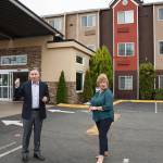 King County Executive Dow Constantine and Auburn Mayor Nancy Backus stand in front of the Clarion Hotel in Auburn on Tuesday July 20. The hotel will be used to house approximately 100 people experiencing homelessness in the area as part of the countys Health Through Housing program. Photo by Henry Stewart-Wood.