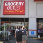 Lorie and Joe Belvins are pictured in front of the donation bins in the back of their Grocery Outlet store in Auburn. The Belvins are accepting donations for people who were affected by the apartment fire in Auburn on July 23. Photo by Henry Stewart-Wood/Sound Publishing