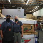 Lorie and Joe Belvins are pictured in front of the donation bins in the back of their Grocery Outlet store in Auburn. The Belvins are accepting donations for people who were affected by the apartment fire in Auburn on July 23. Photo by Henry Stewart-Wood/Sound Publishing