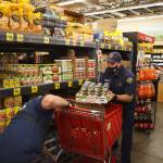 Firefighters pile food into their cart at Grocery Outlet in Auburn.