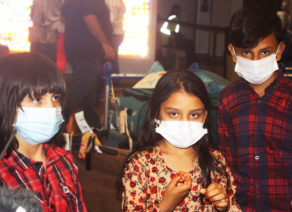 The three children of Kent resident Azizulla Jabarkhail return home safely Oct. 1 at Sea-Tac Airport from Afghanistan after help from Afghan war veterans. STEVE HUNTER, Kent Reporter