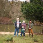 Don Crawley, Janet Crawley, their grandson Henry and Ashley Allan pose for a photo in front of the Green River in the Crawleys backyard. The Crawleys worked with Allan to improve the habitat by planting native species in their backyard. Photo by Henry Stewart-Wood/Sound Publishing