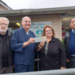 Photo by Robert Whale, Auburn Reporter
From left: Don Gardner, White River Buddhist Temple Sensei Jim Warrick, Randy Nakamoto present a $9,360 check to Debbie Christian, director of the Auburn Food Bank.
