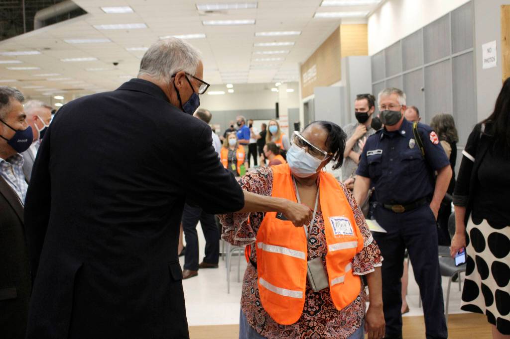 Gov. Jay Inslee (left) bumps elbows with Auburn Vaccine Clinic staff member Mary Johnson (right) on June 22, 2021. Inslee visited the clinic to promote vaccinations in South King County. Sound Publishing file photo