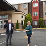 King County Executive Dow Constantine and Auburn Mayor Nancy Backus stand in front of the Clarion Hotel in Auburn on July 20, 2021. The hotel will be used to house approximately 100 people experiencing homelessness in the area as part of the county's Health Through Housing program. Photo by Henry Stewart-Wood/Auburn Reporter