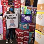 Cheryl Hurst stands among the thousands of diapers being stored at Billy McHales in Federal Way as part of the 2021 March of Diapers charity drive. (Sound Publishing file photo)