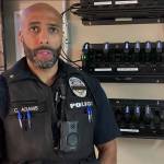 Cmdr. Adams of the Auburn Police Department demonstrates how to use the body-worn cameras. Screenshot courtesy of APD Twitter video