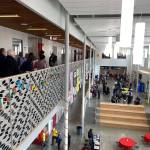 A tour group looks onto the Thomas Jefferson High School commons space below. Olivia Sullivan/the Mirror