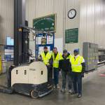 (Left to right) Sergey Alter poses on a forklift with Travis Parke, Seth Myers and Joe Drake at the Safeway distribution center where Alter works. Photo by Henry Stewart-Wood/Sound Publishing