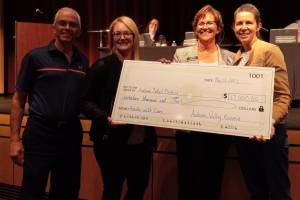 Photo by Robert Whale, Auburn Reporter
Auburn Valley Kiwanian John Partridge, left; Ashley Boyd, Coordinator for Prevention and Intervention Services for the Auburn School District; Rhonda Larson, assistant superintendent for family engagement and student success for the ASD; and Kelley Jensen, current president of the Auburn Valley Kiwanis Club, display the $17,000 check the Kiwanis Club presented to the Auburn School District Board of Directors Monday evening to cover the cost of hosting the Intervention Academy in Auburn this August.