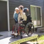 Photo by Henry Stewart-Wood/Sound Publishing
Linda Short and her daughter, Morgan Short, pose for a photo on the wheelchair ramp that was built after an Auburn school bus driver noticed Morgan needed a ramp.