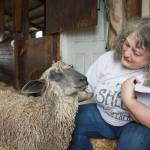 Photo by Henry Stewart-Wood / Sound Publishing
Carolynn Bernard, owner and operator of Bless Ewe Sheep Company, pets one of the sheep on her farm in Enumclaw on Aug. 17, 2021.