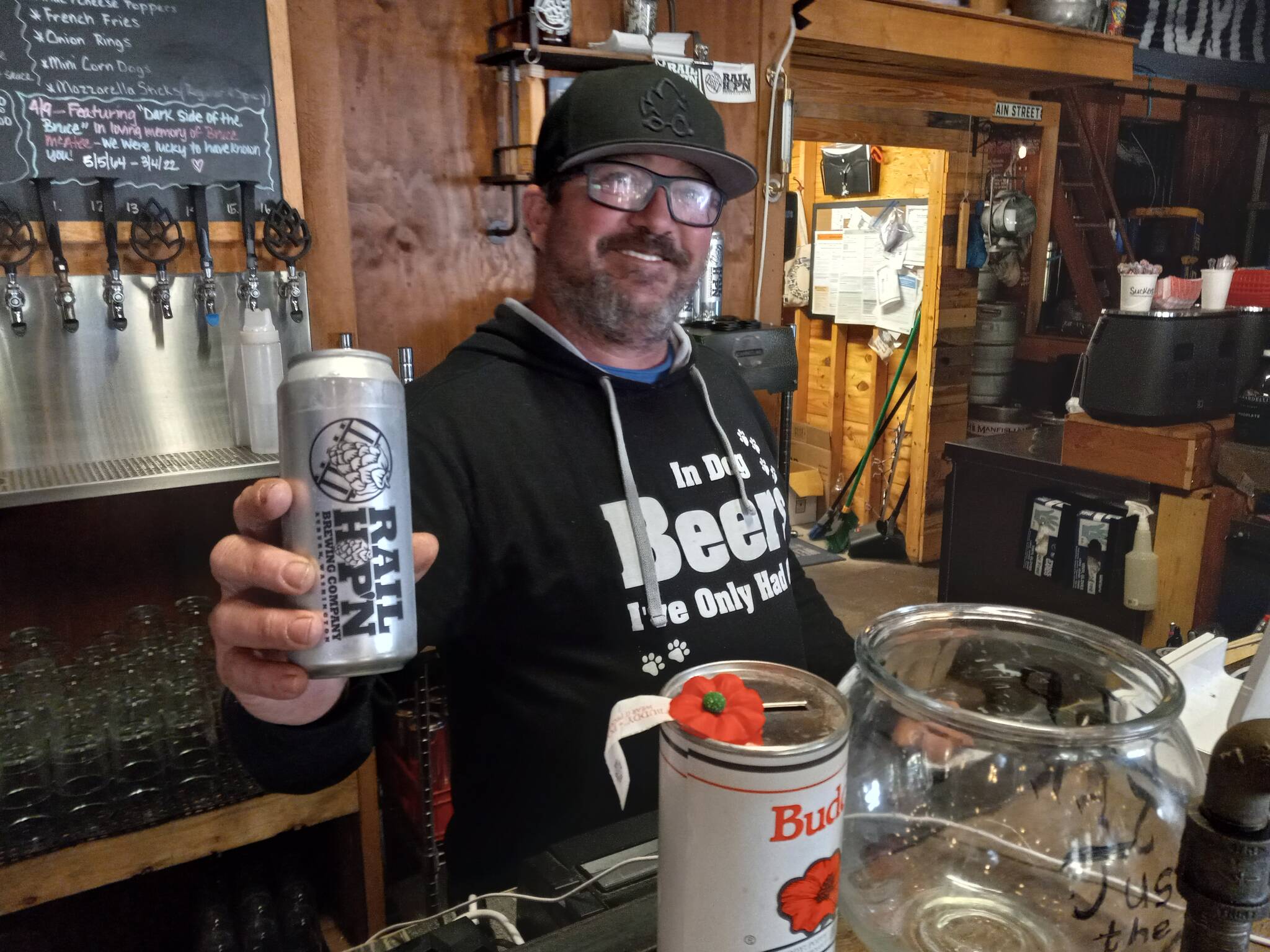 Billy Jack Newman proudly displays Rail Hop n Brewings signature drink and his own creation, jalapeno beer. Photo by Robert Whale, Auburn Reporter.