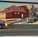 In Seattle artist Mira Hoke's mural, the old Auburn Depot lives again on the west side of the Agrishop. Photo courtesy of Downtown Auburn Cooperative.