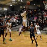 Photos by Ben Ray/Sound Publishing
Auburn junior Luvens Valcin gets up to catch a lob from Tyrell Nichols.