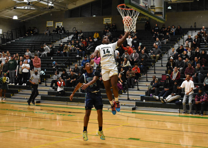 Auburns Luvens Valcin rises above the Ravens on his way to a 12-point performance. Photo by Ben Ray/Sound Publishing
