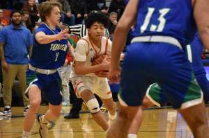 Jamaal Elliott drives to basket during the state playoff game against Mountain View. Photo Credit: Ben Ray/The Reporter