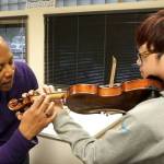 Dr. Quinton Morris helps a student during a lesson.