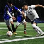 Riversides Daniel Hernandez (10) fights for possession and momentum. Ben Ray / The Reporter