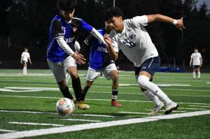 Riversides Daniel Hernandez (10) fights for possession and momentum. Ben Ray / The Reporter