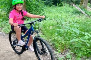 A girl tries out the Cedar Lanes bike trail in Auburn before its opening. Photo courtesy of Auburn Parks, Arts and Recreation.