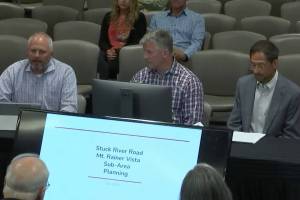 Jeff Tate, director of community development for the city of Auburn, Segale Properties spokesman Mike Pruett and Mark Segale address the Auburn City Council about the future redevelopment of key Segale holdings in Auburn, among them the gravel mining operation established 40 years ago on the citys south end. (Photo by Robert Whale, Auburn Reporter)