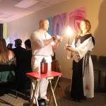 High Priest Kalu and High Preistess Syleena Call The Corners, a small ritual where a candle is lit at each direction of the Earth as the elements each direction represents is called upon. Here they call on the guardian of the watchtower of the South, represented by red which symbolizes fire. Photo by Bailey Jo Josie/Sound Publishing.