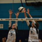 Senior Sydney Priebe and Kate Danielson go up for a block. Ben Ray/ The Reporter