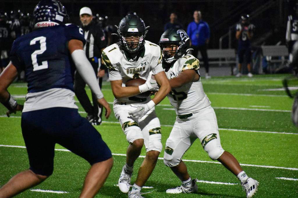 A handoff in the red zone between Bielza and Whitehall-Gilkes. Ben Ray / The Reporter