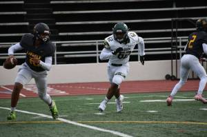 An Auburn defensive lineman pursues the Lincoln quarterback. Ben Ray / The Reporter