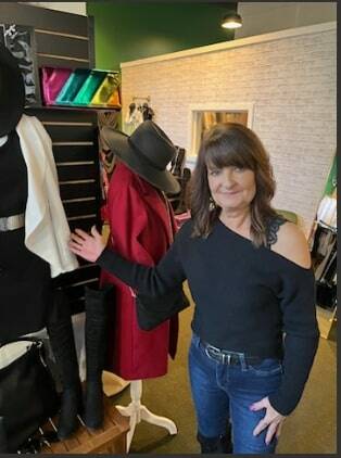 Heather Feller discusses some of the snappy clothes she has to sell at Emerald City Fashion, her clothing boutique at 50 West Main in downtown Auburn. Photo by Robert Whale, Auburn Reporter