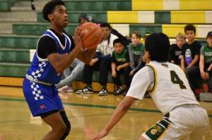 Senior Carmelo Jacobs takes a three pointer against Kentridge. Ben Ray / The Reporter