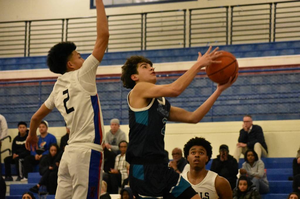Jaiden Barba goes up for a layup with a Royal defender contesting his shot.