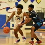 Kent-Meridian outlasted Auburn Riverside on Dec. 11 with a 68-67 win at Kent-Meridian. Pictured: Freddie Boles takes on a Kent-Meridian player. Read more about the game at www.auburn-reporter.com. Ben Ray / The Reporter