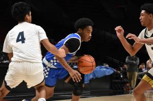 Auburn Mountainview High Schools boys basketball team played in the Court of Dreams invitational on Dec. 20 at the Moda Center in Portland. The Lions defeated Lindbergh High School, 68-43. Pictured: Melo Jacobs dribbles past a Lindbergh defender. (Photos by Ben Ray/The Reporter)