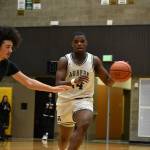 Trojan senior Luvens Valcin dribbles the ball for the Auburn High School. Ben Ray / The Reporter