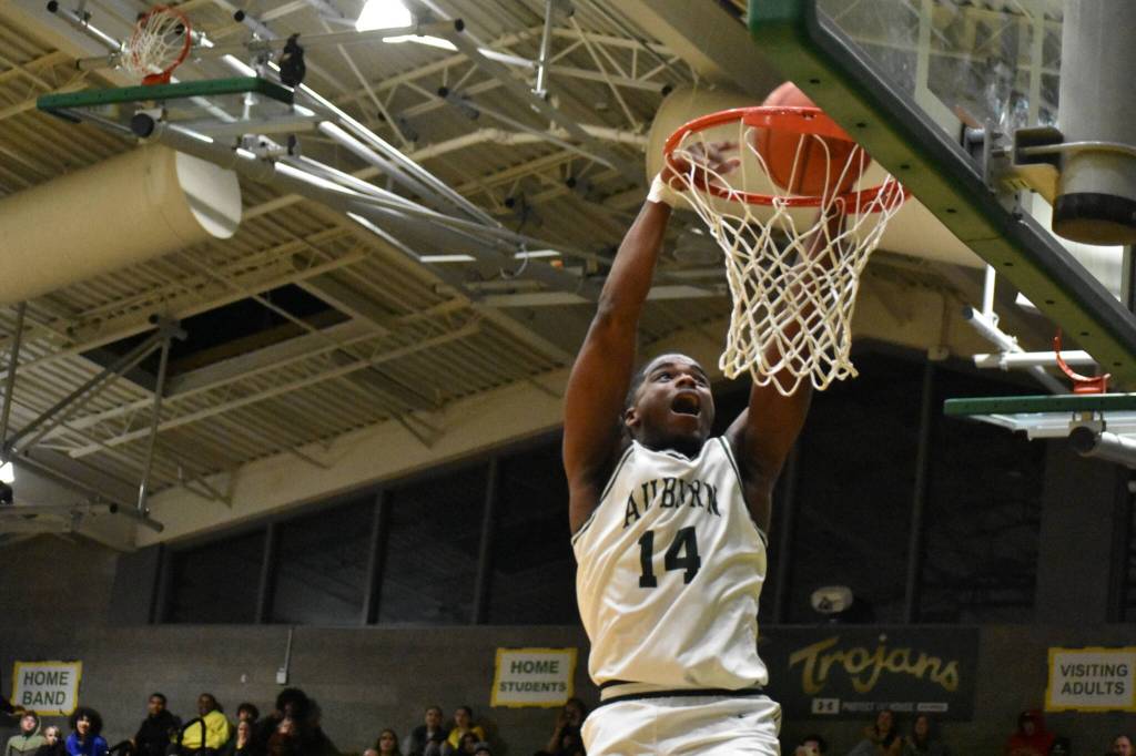 Trojan senior Luvens Valcin takes flight against the Abes of Lincoln. Ben Ray / The Reporter