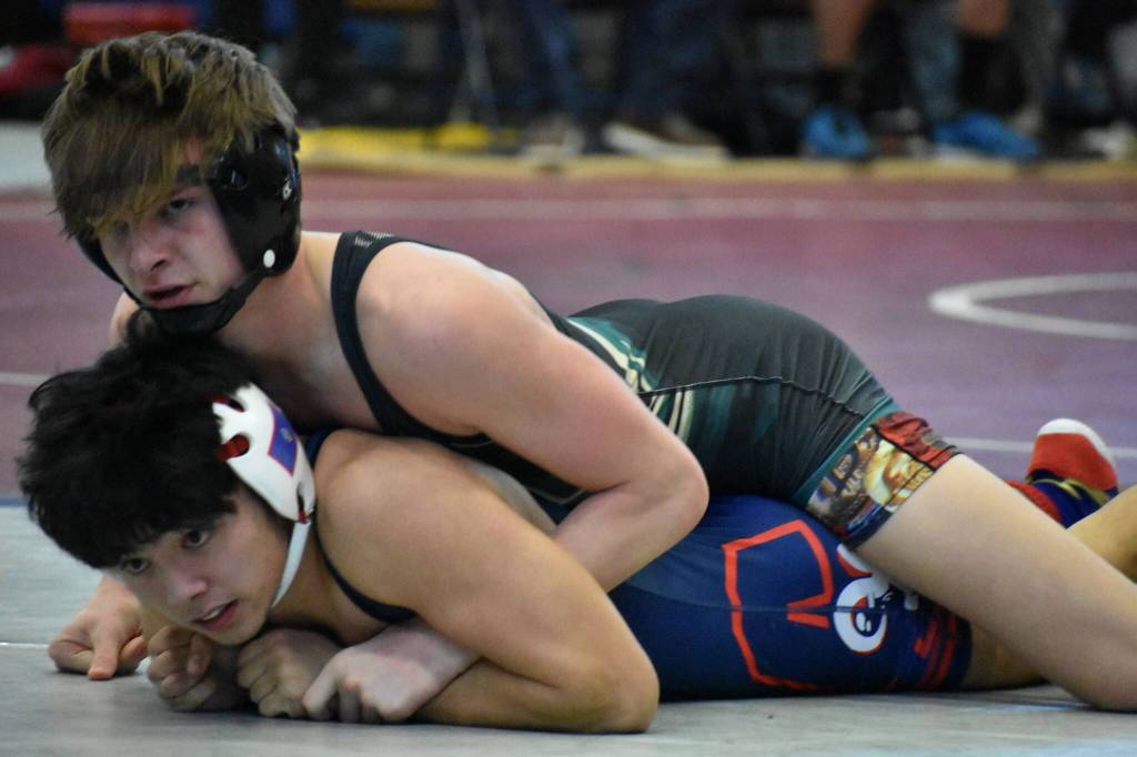 Auburn Trojan wrestler eyes his coach for a move recommendation. Ben Ray / The Reporter