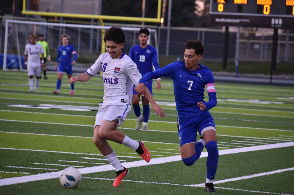 Kent-Meridian and Federal Way soccer players fight for possession earlier in the season. Ben Ray / The Reporter