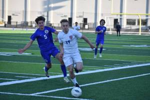 Davyd Fedina chases down the ball at Federal Way Memorial Field against Stadium. Ben Ray / The Reporter