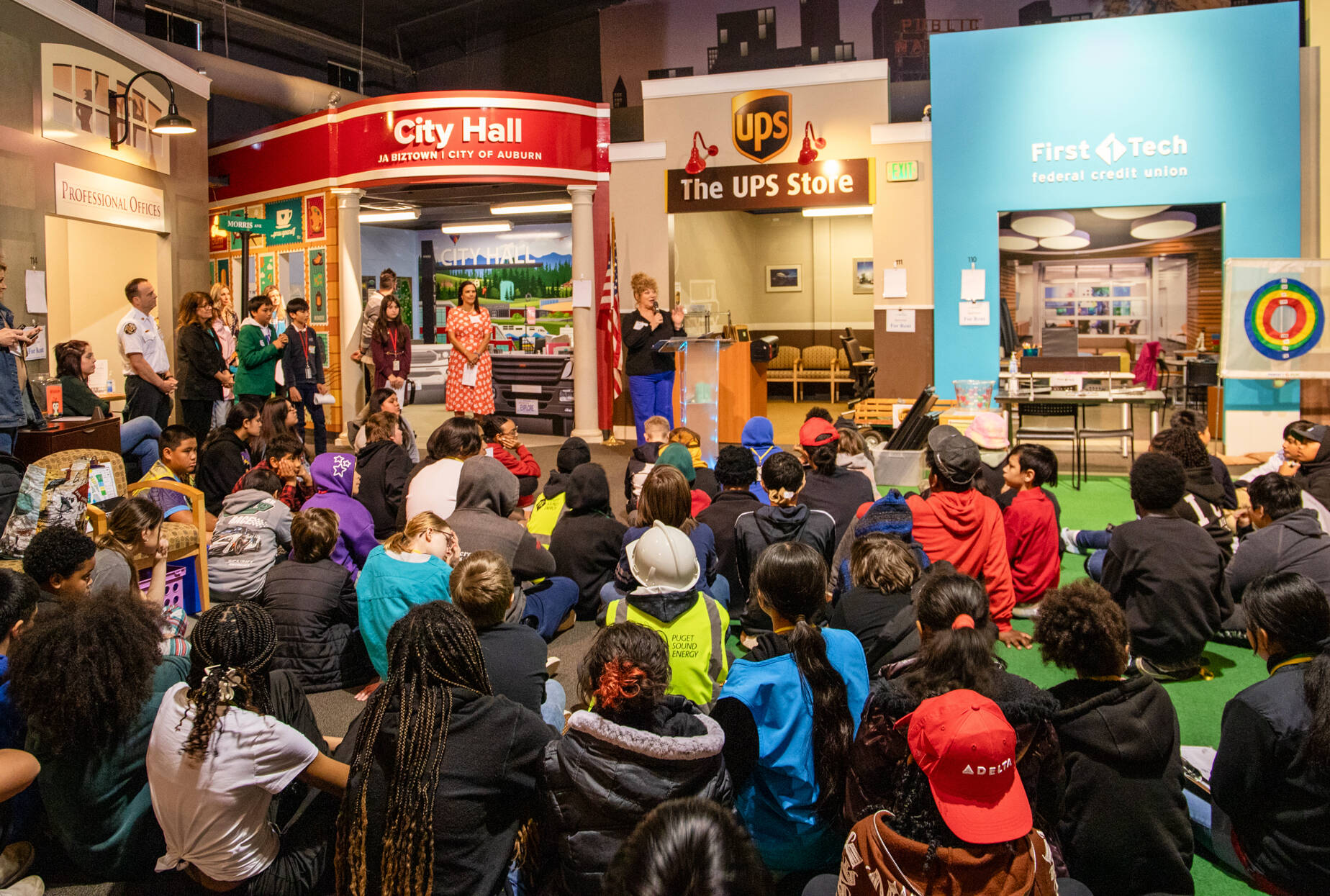 Auburn Mayor Nancy Backus addresses students gathered to celebrate and cut the ribbon on Junior Achievements new Auburn City Hall storefront at JA Biztown on Perimeter Road in Auburn. Photo courtesy of Junior Achievement