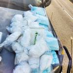 Meth and pills displayed on a hood of a car from a major drug bust that included nine South King County residents. COURTESY PHOTO, U.S. Department of Justice
