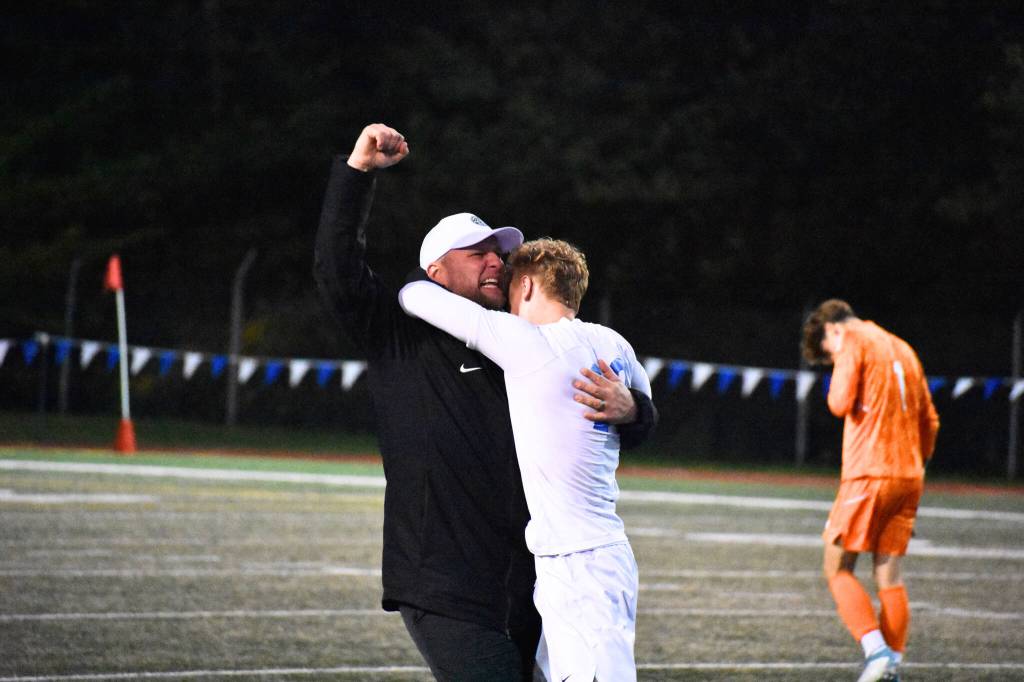 Manager Joey West and Davyd Fedina celebrate the 3-2 win over Shorewood. Ben Ray / The Reporter